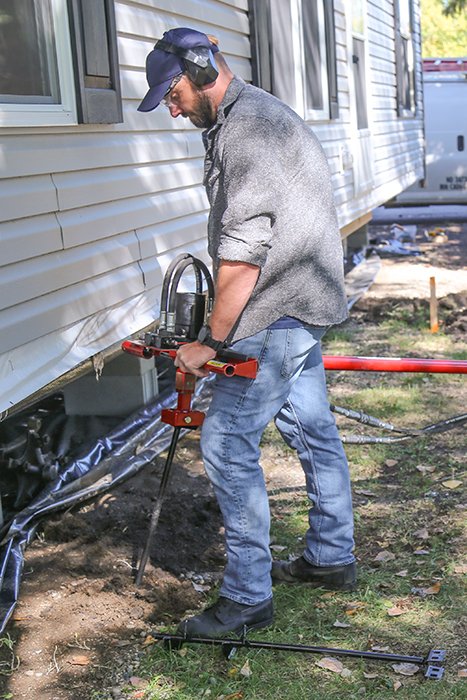 Hydraulic earth drill installing - anchors for mobile homes