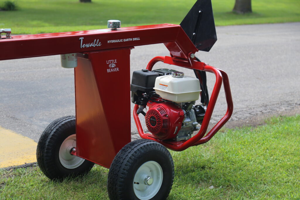 Towable earth auger engine