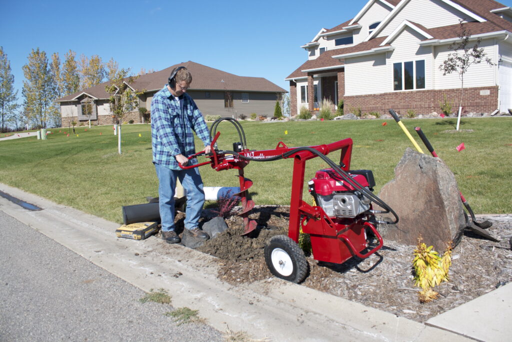 un-towable earth auger installing a mailbox post